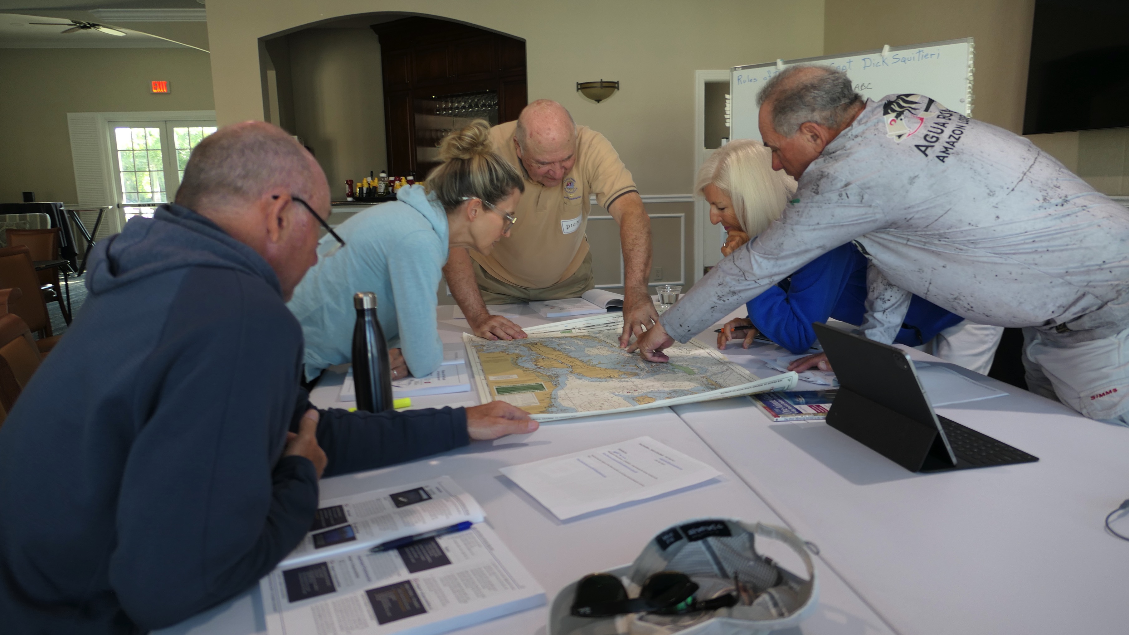 Instructor teaching chart reading and navigation during Marine Navigation course